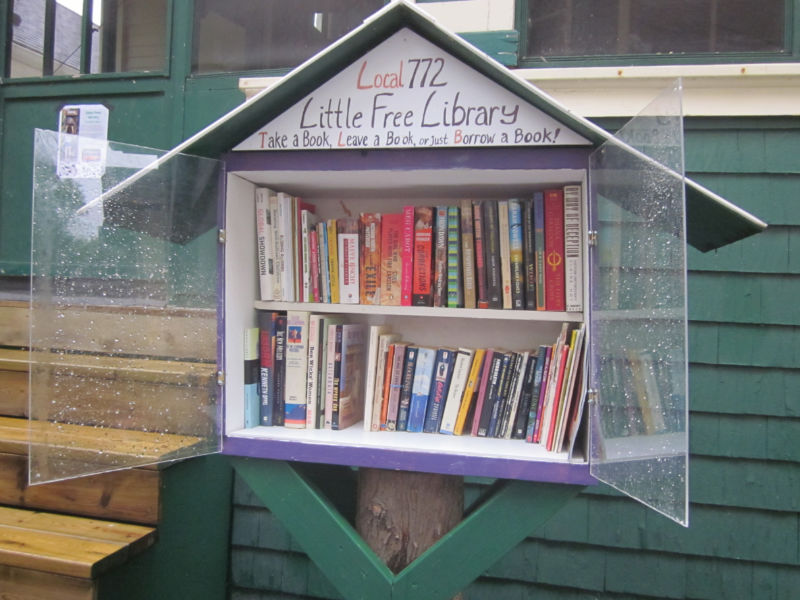 Open Little Free Library box containing two shelves filled with books