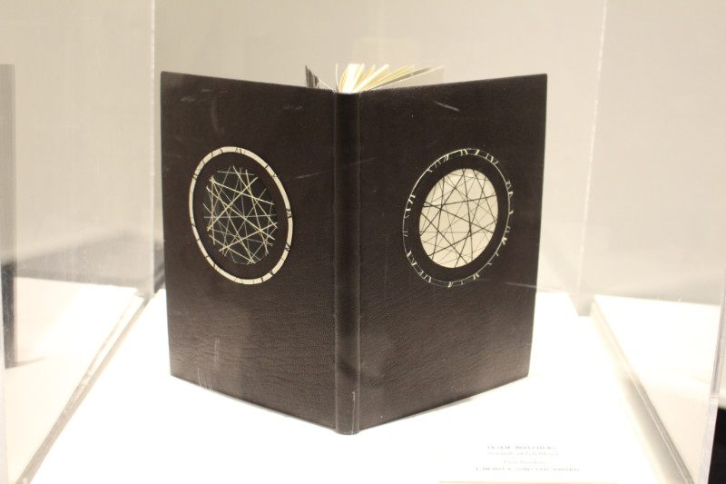 Brown book with astronomical design on it at Art of the Book