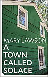 The cover of A Town Called Solace by Mary Lawson shows the side of a green wooden house with white framed windows